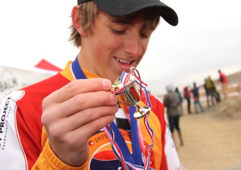 Gage Hecht pulls an item out of a prize bag