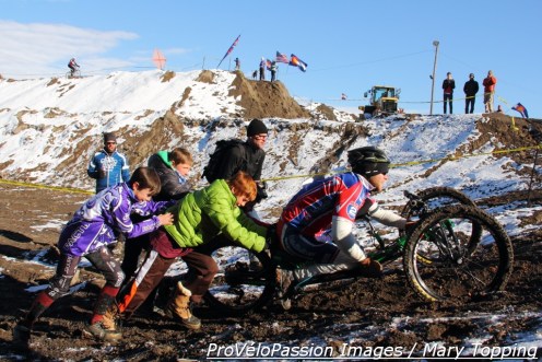Assisting a hand cyclist out of the construction pit at MUCCY
